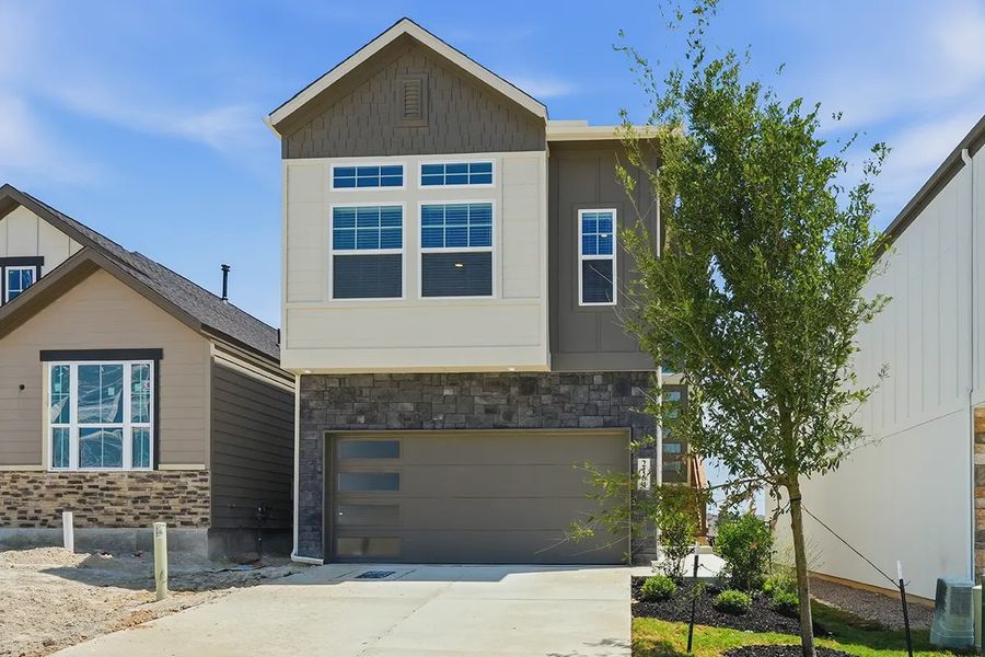 Front exterior of a new home in Prominence Urban, San Antonio, TX, highlighting curb appeal (Image 22).