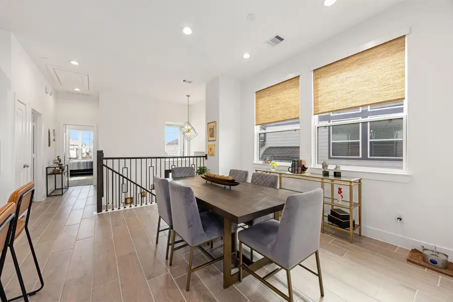 As you make your way upstairs, you will find the spacious dining room area that opens to the kitchen and living room.