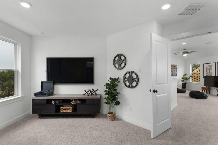 Carpeted living area with recessed lighting, baseboards, and ceiling fan
