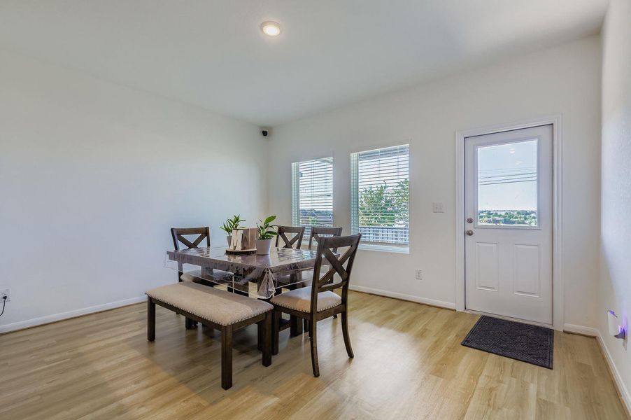 Dining space with light wood-style flooring and recessed lighting