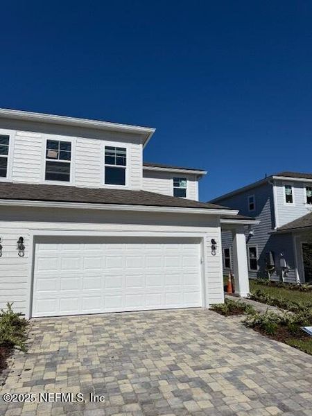 Front exterior of a new home in Brook Forest - Townhomes, St. Augustine, FL, highlighting curb appeal (Image 1). Front exterior of a new home in Brook Forest - Townhomes, St. Augustine, FL, highlighting curb appeal (Image 1).