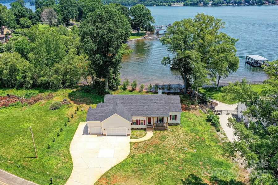 Waterfront, Custom Designed Home with 3 Bedroom, 2.5 Bath, Ranch & 3 Car Garage, with views of Lake from front & back of home, located on Kiser Island with NO HOA!