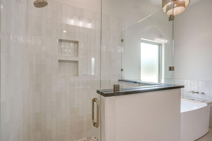 Bathroom featuring a stall shower and a freestanding tub Bathroom featuring a stall shower and a freestanding tub