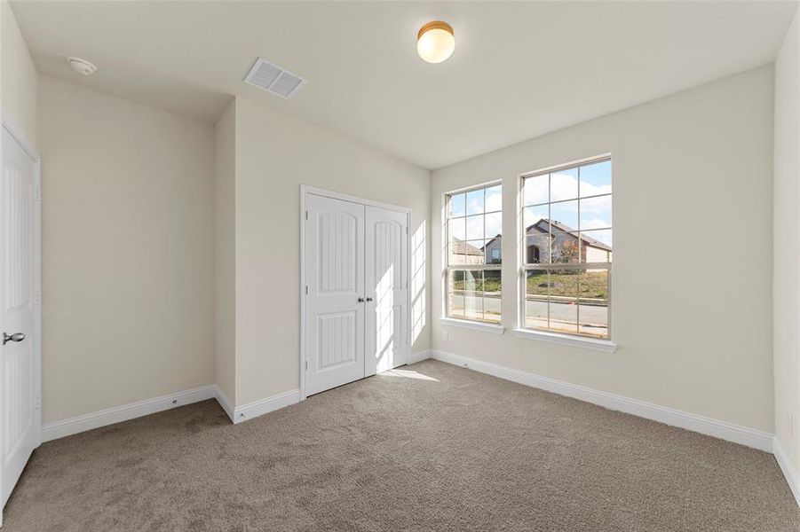 Unfurnished bedroom featuring a closet and carpet floors