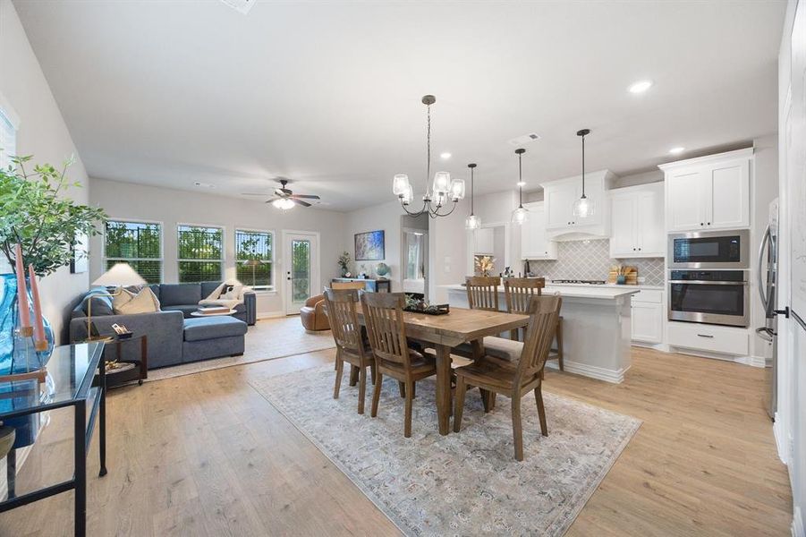 Dining space with premium lighting,  light wood-style floors, and recessed lighting