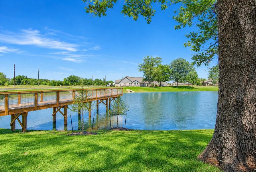 This photo captures a view of the home from across the lake and showcases this remarkable pier that extends far out into the lake and is ideal for fishing or simply watching a later afternoon sunset.