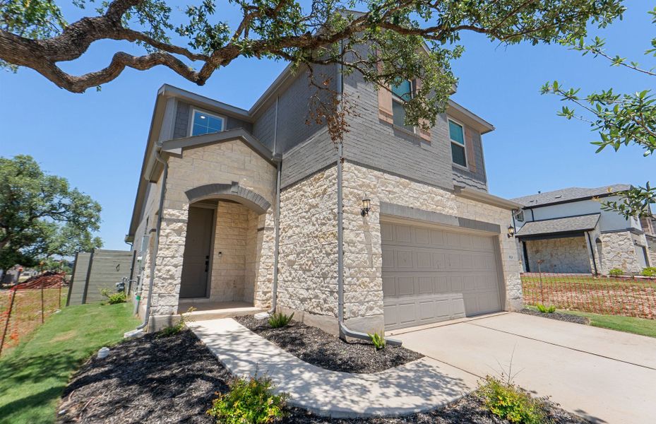 Front exterior of a new home in Wolf Ranch, Georgetown, TX, highlighting curb appeal (Image 1). Front exterior of a new home in Wolf Ranch, Georgetown, TX, highlighting curb appeal (Image 1).