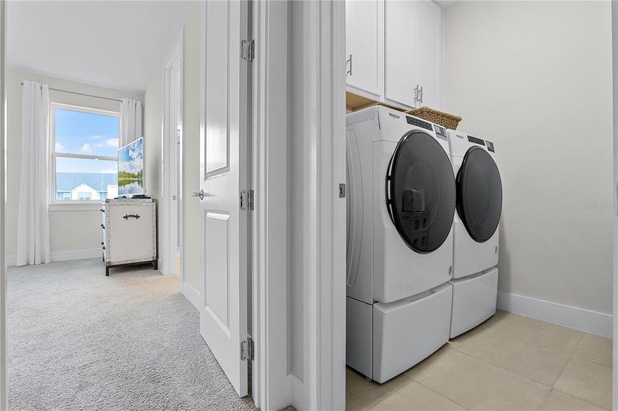 Laundry room with upper cabinetry Laundry room with upper cabinetry