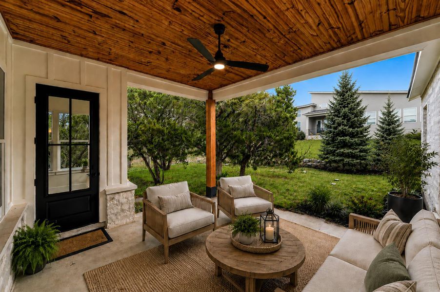 Rich wood plank ceilings shelter a concrete patio overlooking a manicured lawn.Virtual Staging. Rich wood plank ceilings shelter a concrete patio overlooking a manicured lawn.Virtual Staging.