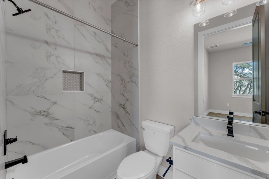 Bathroom with vanity and tub / shower combination