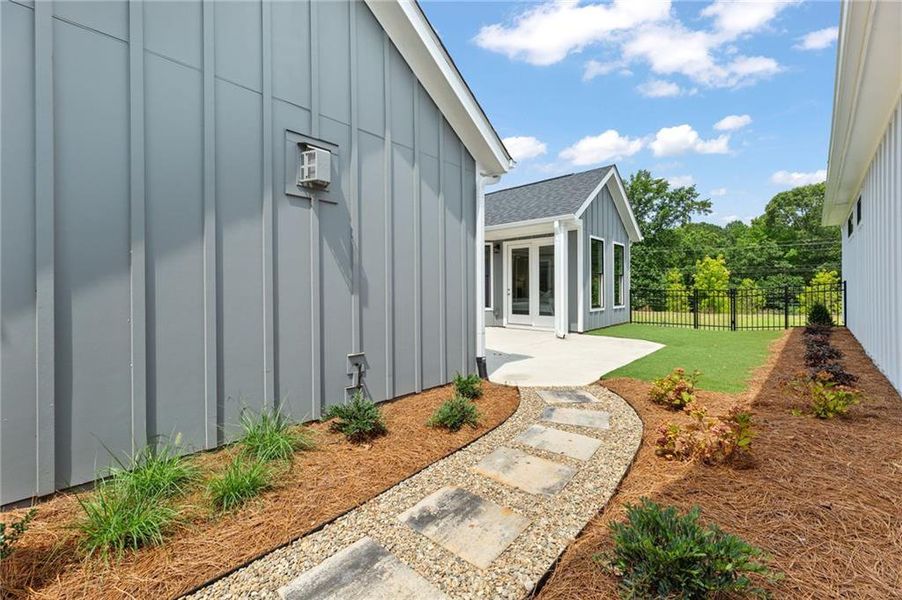Front exterior of a new home in The Courtyards at Bailey Farm, Dacula, GA, highlighting curb appeal (Image 19).