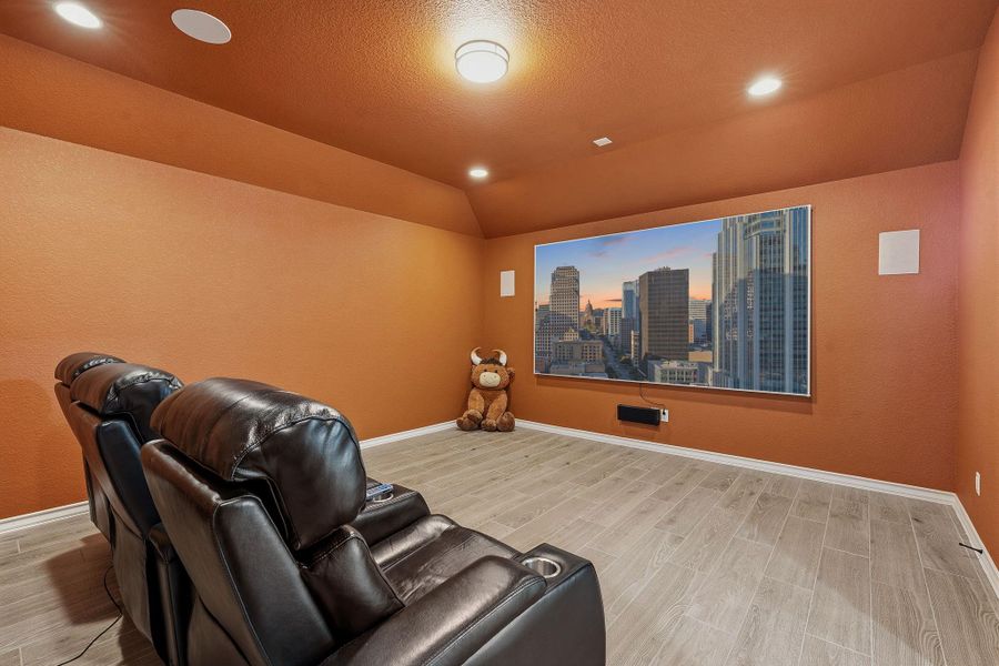 Indulge in cinematic experiences within this dedicated home theater, featuring comfortable seating and ambient lighting. Indulge in cinematic experiences within this dedicated home theater, featuring comfortable seating and ambient lighting.