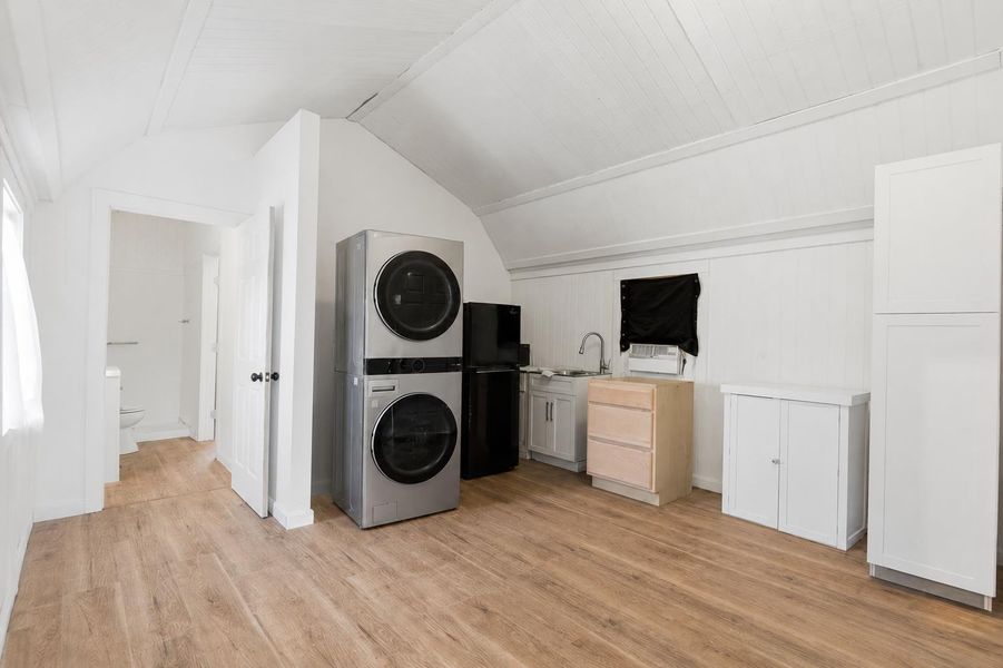 Stackable washer and dryer, refrigerator, sink and storage makes the kitchen the perfect space.