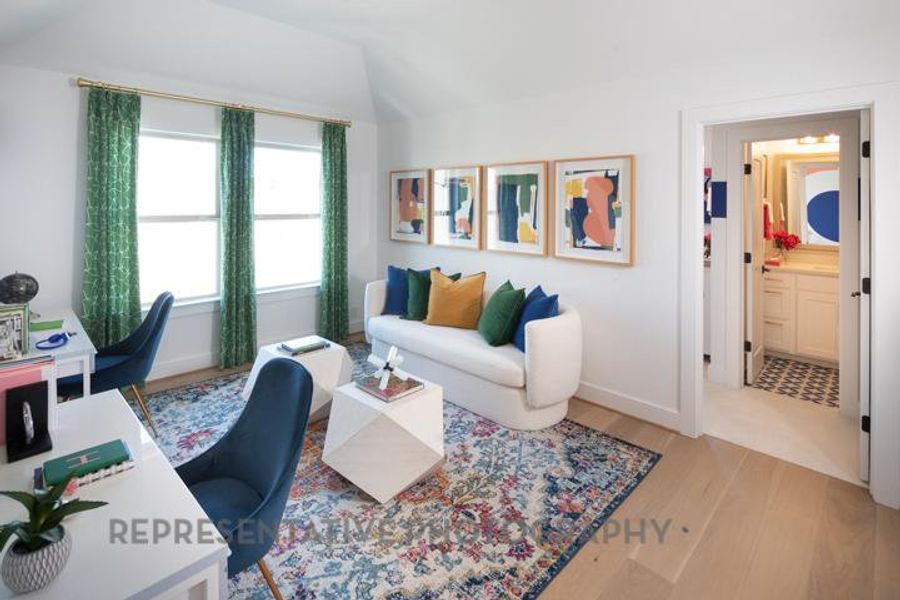 Office space featuring vaulted ceiling, light wood-style flooring, and baseboards Office space featuring vaulted ceiling, light wood-style flooring, and baseboards