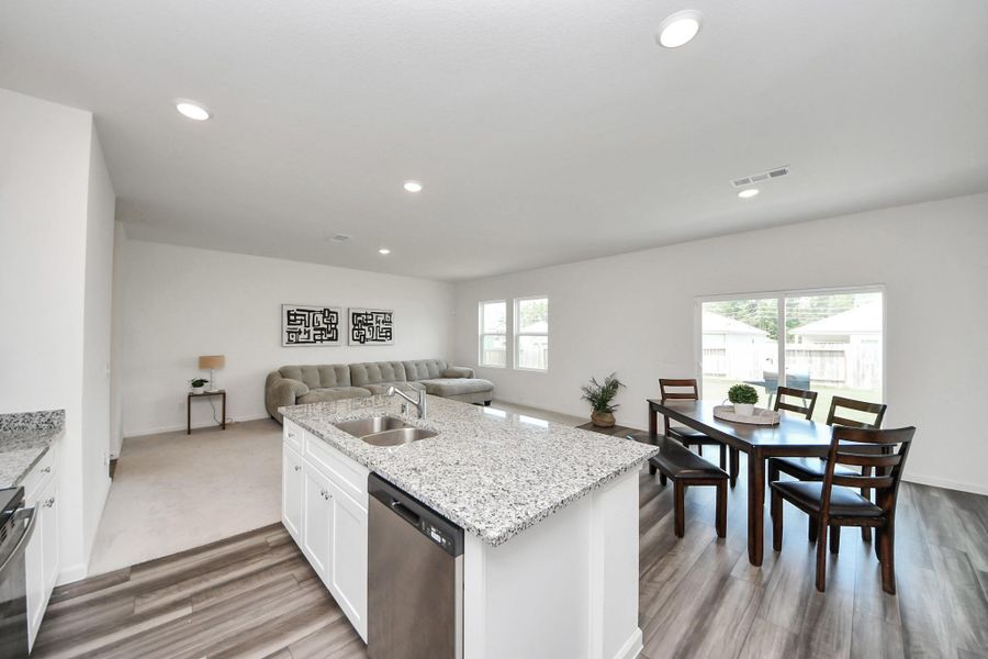 A view from kitchen into dining and living room spaces.