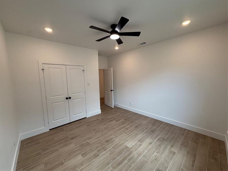 Unfurnished bedroom featuring recessed lighting, ceiling fan, light wood-style flooring, and a closet Unfurnished bedroom featuring recessed lighting, ceiling fan, light wood-style flooring, and a closet