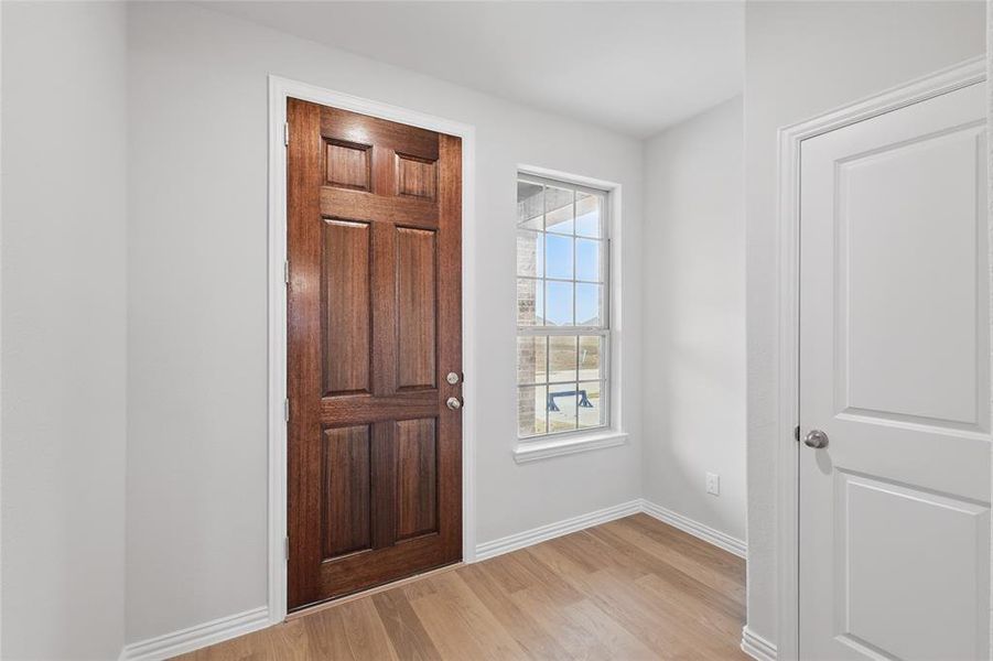 Entrance foyer featuring light wood-style flooring and baseboards