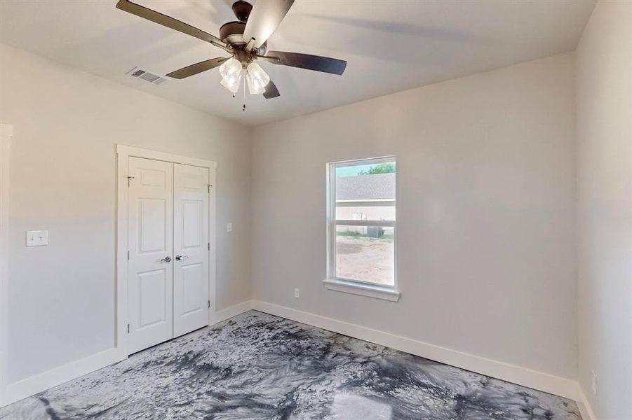 Spare room with ceiling fan