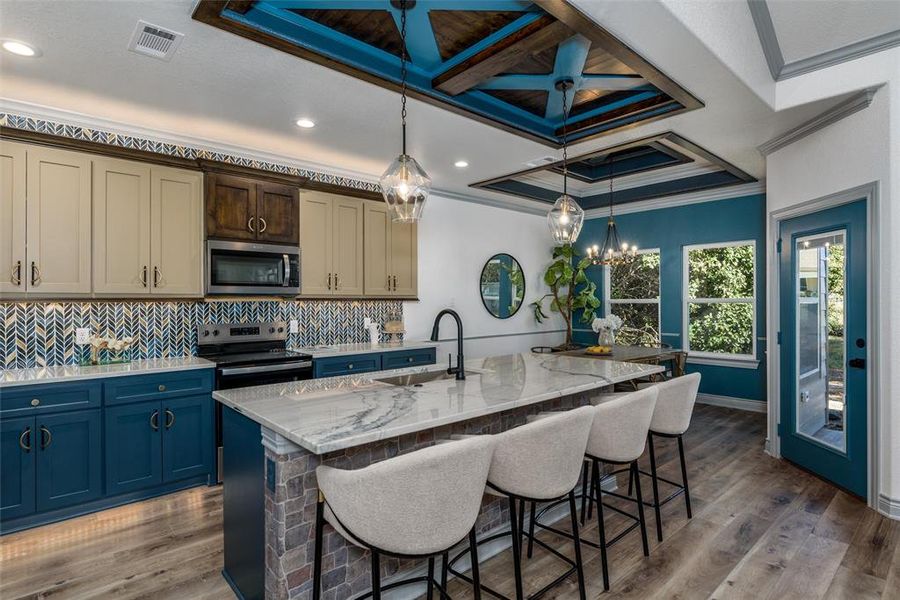 Kitchen with island seating and custom ceiling design.