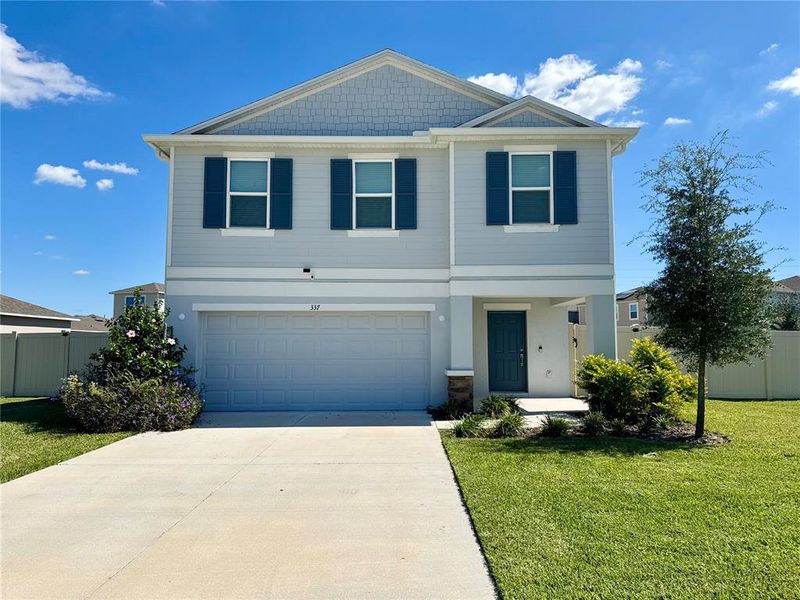 Front exterior of a new home in Marion Creek, Haines City, FL, highlighting curb appeal (Image 2).