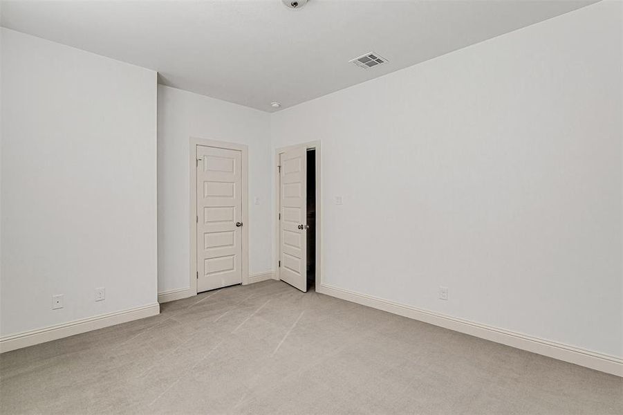 Unfurnished room with light colored carpet and baseboards