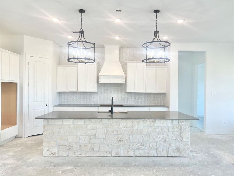Kitchen backsplash to ceiling with hidden outlets. Will be equipped with high-end Bosch appliances