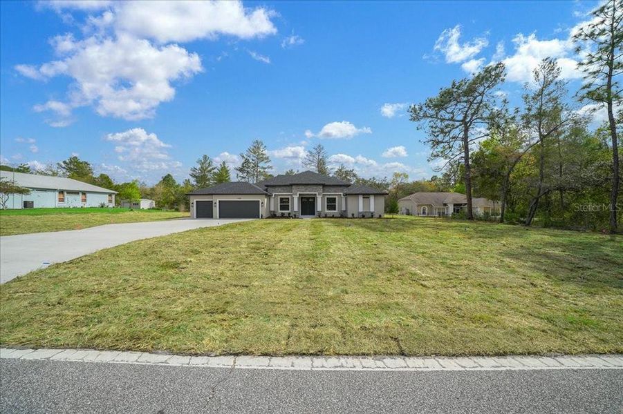 Front exterior of a new home in , Weeki Wachee, FL, highlighting curb appeal (Image 26).