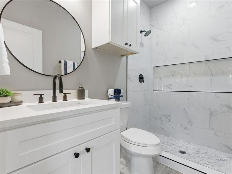 Full bathroom with vanity and a stall shower Full bathroom with vanity and a stall shower