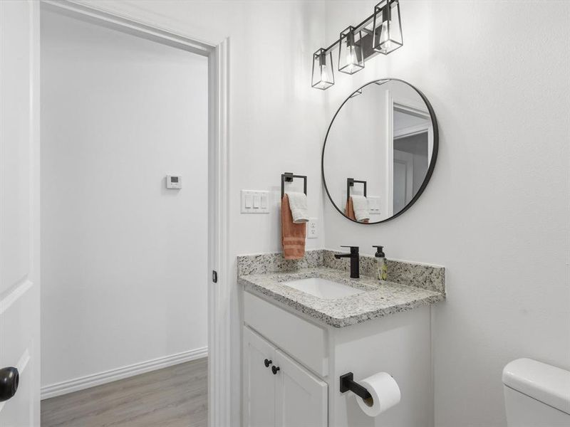 Full bathroom has built in cabinet and vanity.