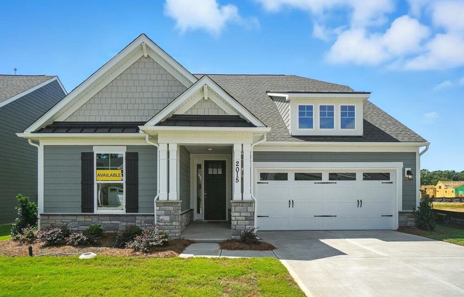 Front exterior of a new home in Heritage - 55+ Community, Indian Trail, NC, highlighting curb appeal (Image 2). Front exterior of a new home in Heritage - 55+ Community, Indian Trail, NC, highlighting curb appeal (Image 2).