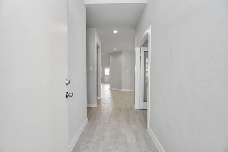 As you step into the threshold of this luxurious home, you'll soon be welcomed by an elegant glass door (to be installed). Inside, soaring ceilings amplify the spaciousness, while the refined wood-look tile flooring and oversized baseboards exude sophistication and charm. Sample photo of completed home with similar floor plan. Actual colors and selections may vary. As you step into the threshold of this luxurious home, you'll soon be welcomed by an elegant glass door (to be installed). Inside, soaring ceilings amplify the spaciousness, while the refined wood-look tile flooring and oversized baseboards exude sophistication and charm. Sample photo of completed home with similar floor plan. Actual colors and selections may vary.