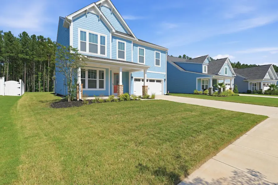 Front exterior of a new home in , Ravenel, SC, highlighting curb appeal (Image 23).