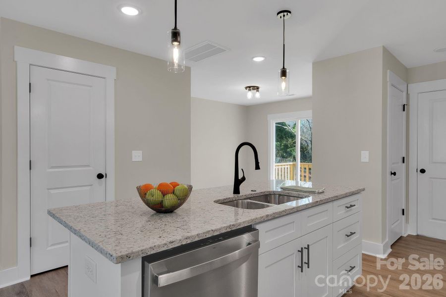 Functional kitchen island featuring an undermount sink and built-in dishwasher, offering both convenience and a clean, streamlined look