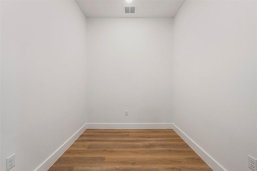 Unfurnished room featuring light wood finished floors and baseboards