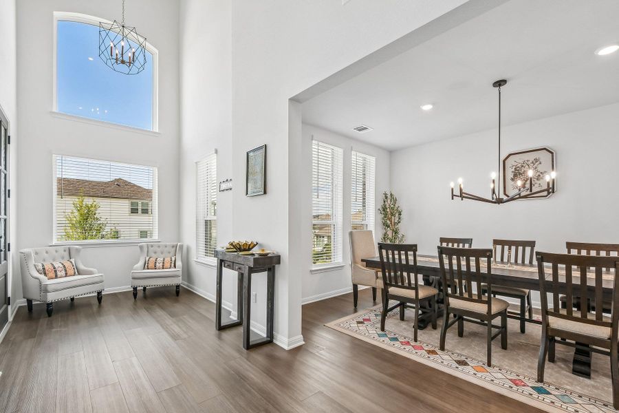 An open floorplan with vaulted ceilings and large windows creates an airy and well-lit interior space.