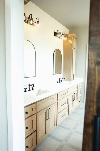 Double vanity with dual undermount sinks and matte black hardware