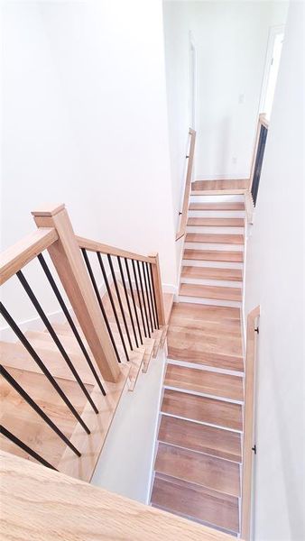 Staircase featuring wood-type flooring