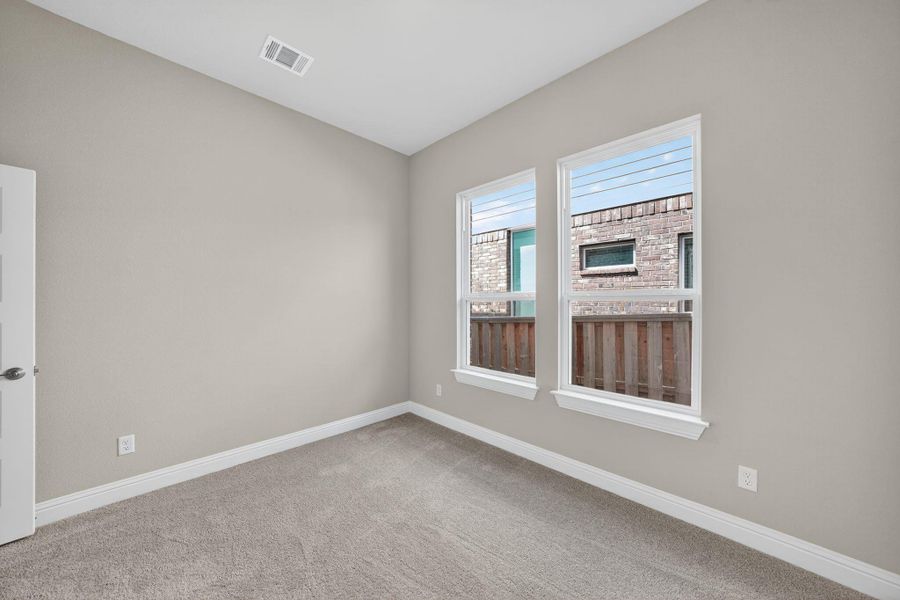Empty room with carpet floors and baseboards Empty room with carpet floors and baseboards