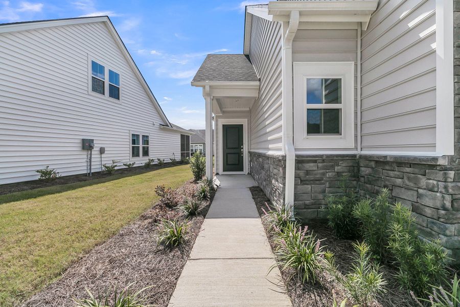 Front exterior of a new home in Horizons at Summers Corner | 55+: The Cottages, Summerville, SC, highlighting curb appeal (Image 21). Front exterior of a new home in Horizons at Summers Corner | 55+: The Cottages, Summerville, SC, highlighting curb appeal (Image 21).