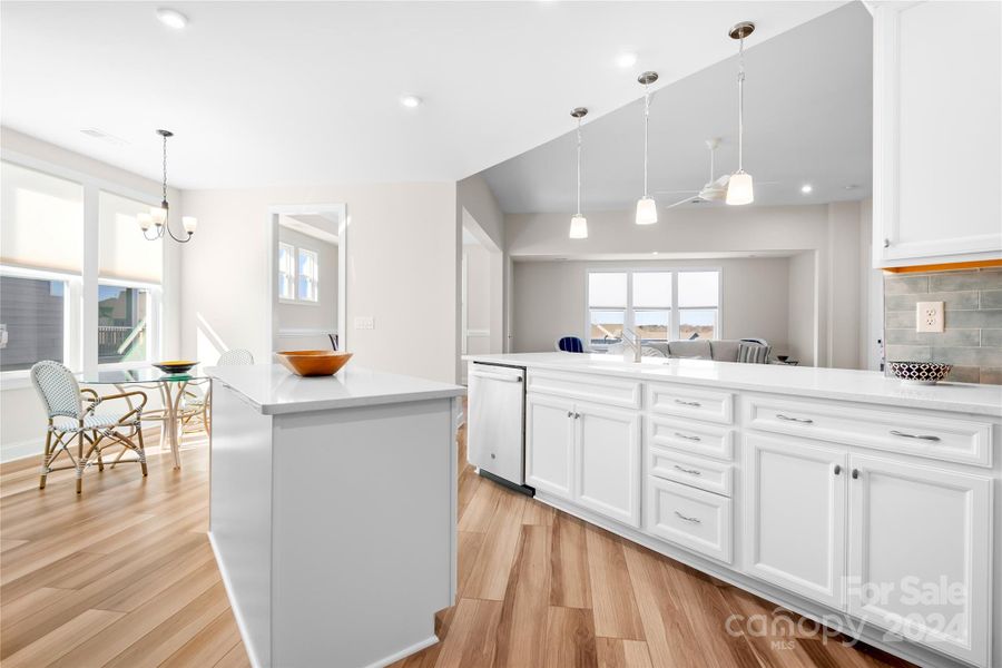 The Chef in your family will fall in love with this breathtaking Kitchen with white cabinets, quartz counters, pendant lighting, center island  and low maintenance LVP flooring.