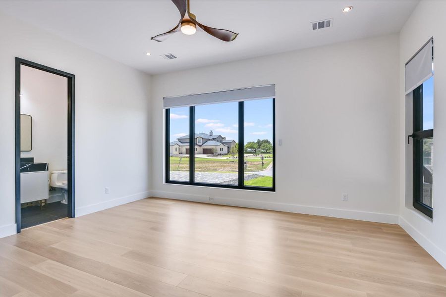 Spare room featuring light wood finished floors, plenty of windows, ceiling fan, and recessed lighting Spare room featuring light wood finished floors, plenty of windows, ceiling fan, and recessed lighting