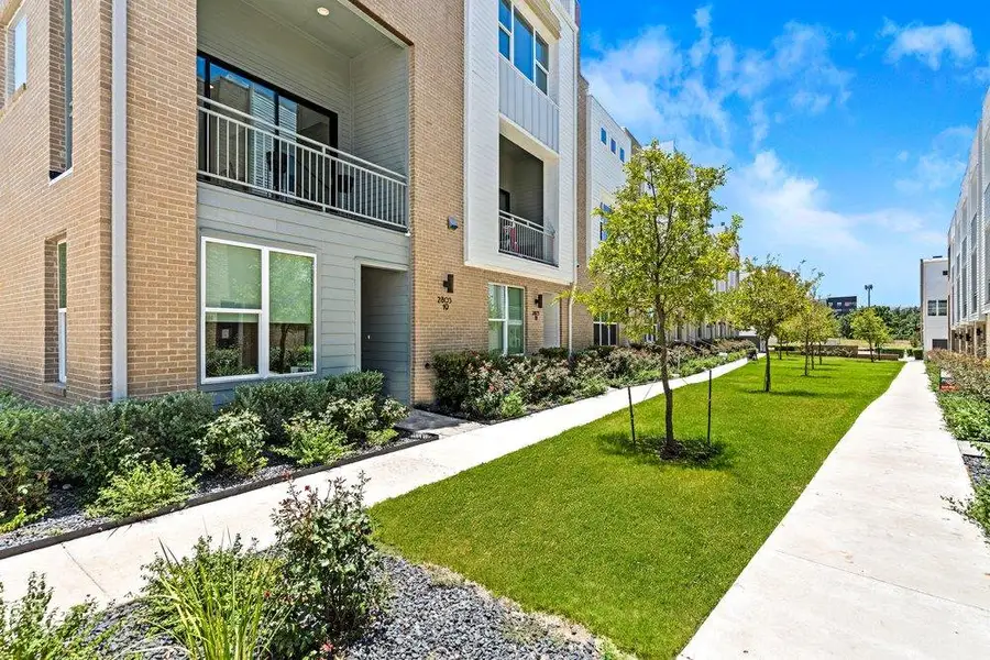 Contemporary multi-level townhomes offer private balconies and a well-kept common green space. Contemporary multi-level townhomes offer private balconies and a well-kept common green space.