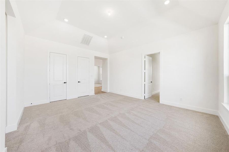 Unfurnished bedroom featuring light carpet and recessed lighting