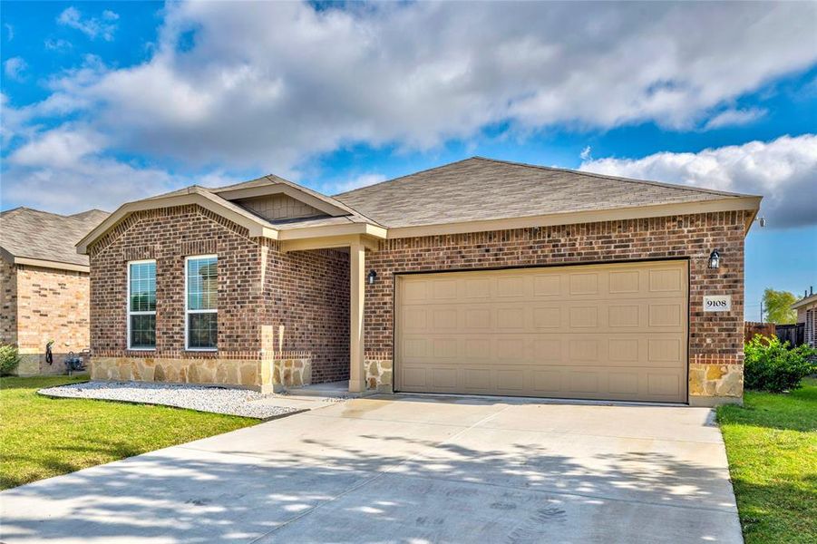 Ranch-style house featuring brick siding, roof with shingles, concrete driveway, an attached garage, and a front yard Ranch-style house featuring brick siding, roof with shingles, concrete driveway, an attached garage, and a front yard