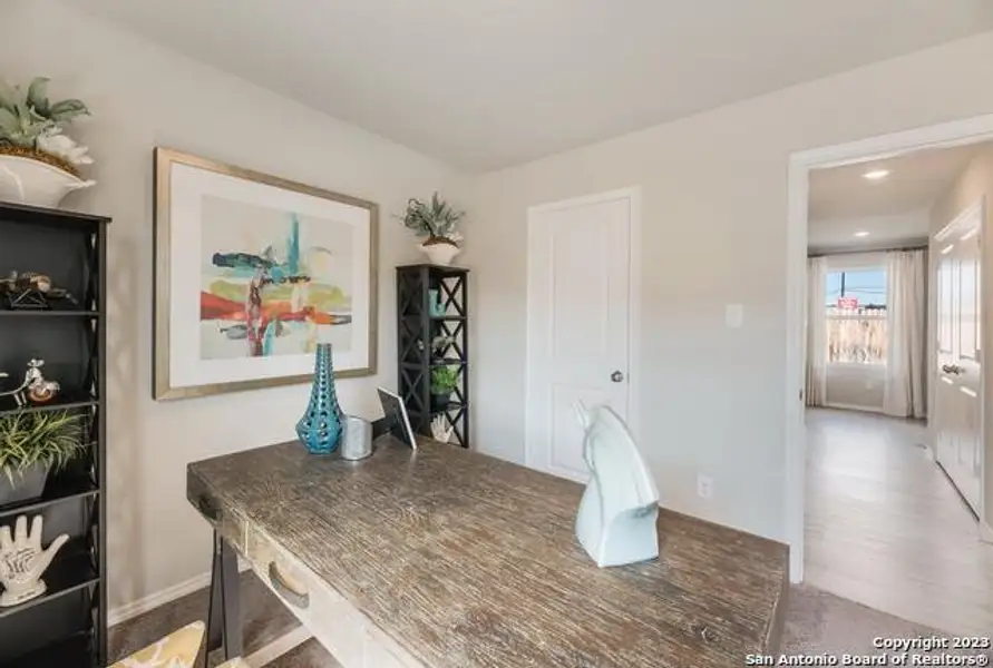 Office space featuring baseboards and wood finished floors Office space featuring baseboards and wood finished floors