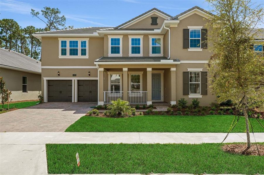 Front exterior of a new home in Palms at Windermere, Windermere, FL, highlighting curb appeal (Image 21).