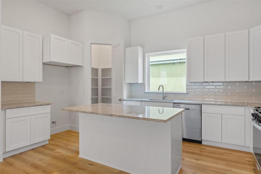 This stylish open kitchen boasts quartz countertops, chrome appliances, and a seamless flow into the main living spaces—perfect for entertaining. This stylish open kitchen boasts quartz countertops, chrome appliances, and a seamless flow into the main living spaces—perfect for entertaining.