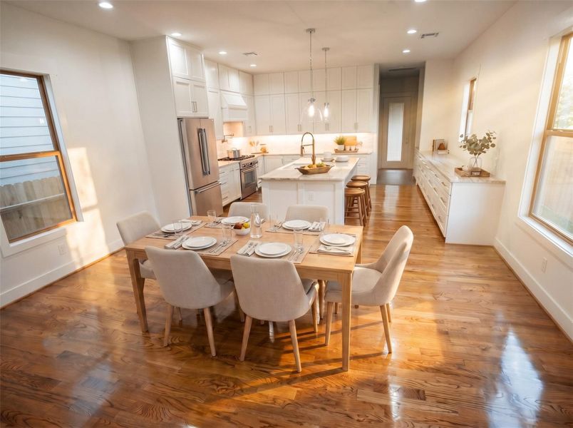 The heart of the home. This open-concept living, dining, and kitchen space showcases real hardwood floors, custom cabinetry, abundant storage, and designer finishes—perfect for everyday living, entertaining, and creating lasting memories.