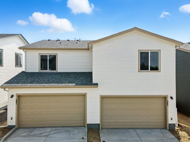 Front exterior of a new home in Pintail Commons at Johnstown Village, Johnstown, CO, highlighting curb appeal (Image 24).