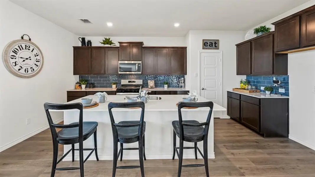 Kitchen island with a white countertop and seating for three